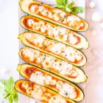 zucchini pizza boats on a white plate