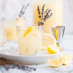 lavender lemonade cocktail with white background a pitcher of lemonade